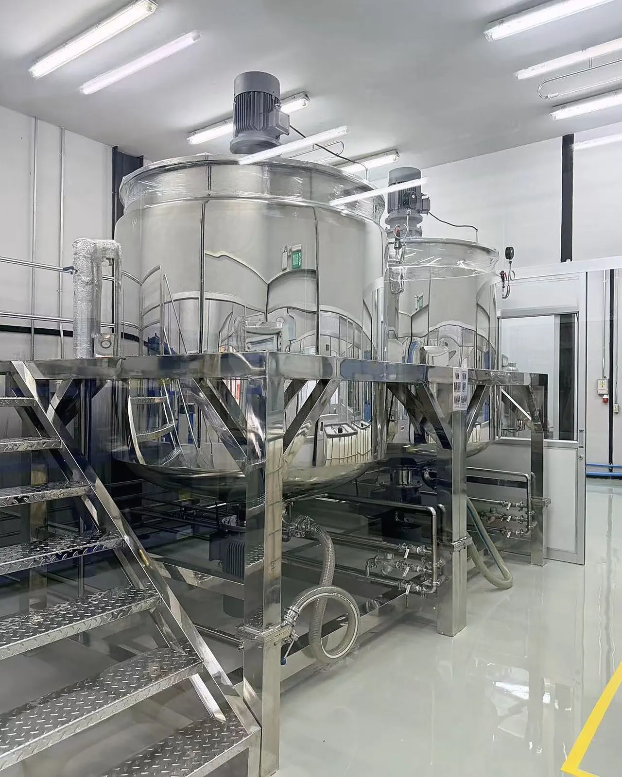 Close view of stainless-steel compounding tanks and piping at Sawatdee Group’s Samut Prakan factory.